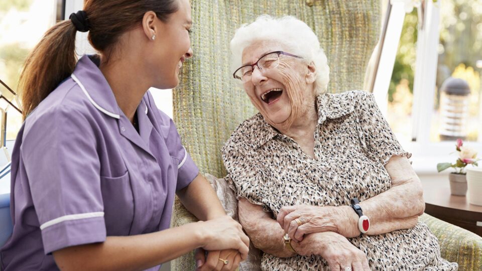 Healthcare professional visiting elderly woman